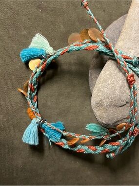 Braided string cord with tassels,coin drops, and adj fit
